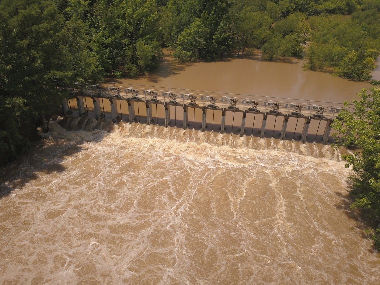 Water flowing backward over gates at Lake Conway Dam (image taken June 3, 2019)