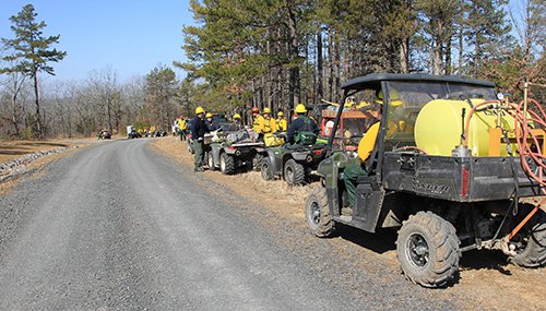 Fire crew and vehicles parked along road