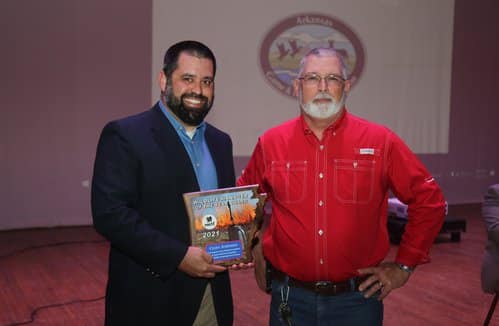 AGFC biologist Clint Johnson (left) received the National Wild Turkey Federation’s 2021 Arkansas Wildlife Manager of the Year Award from former NWTF Arkansas chapter president Terry Thompson.