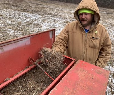 Ben Thesing with CAW shows native seed in hopper