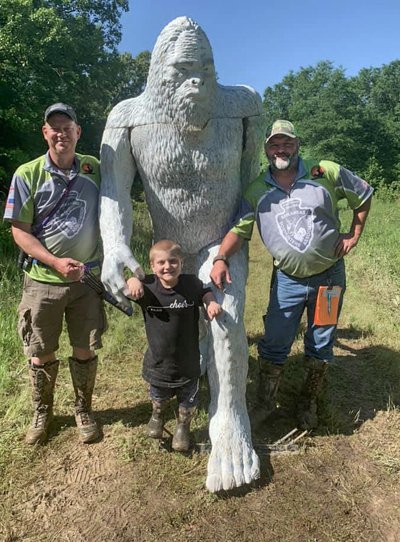 Arkansas Bowhunters Association members and young man with sasquatch target