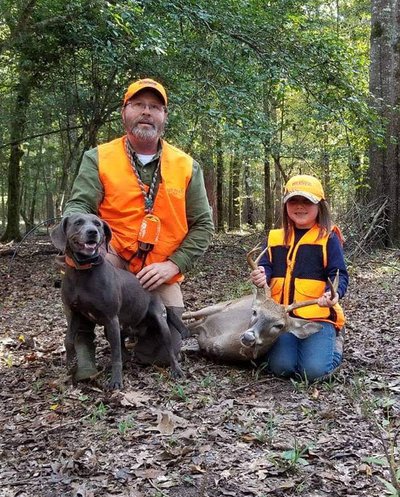 Hunter with recovered deer from help of tracking dog