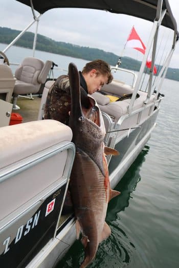 Chris Cantrell with giant paddlefish. Image courtesy Andy Jeffries.