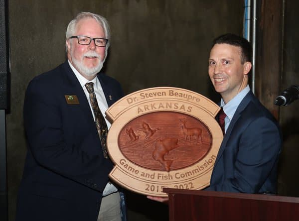 Dr. Steven Beaupre (left) receiving a gift from AGFC Chief of Staff Chris Racey during his final meeting as Ex-Officio Commissioner with the AGFC.