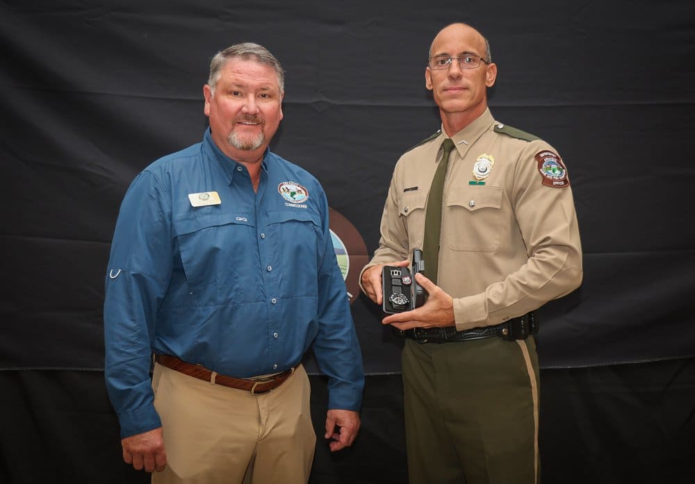 AGFC Commissioner Bill Jones presented Crawford with a military-grade watch in addition to his plaque as a token of appreciation for Crawford’s accomplishments. Photo by Mike Wintroath.