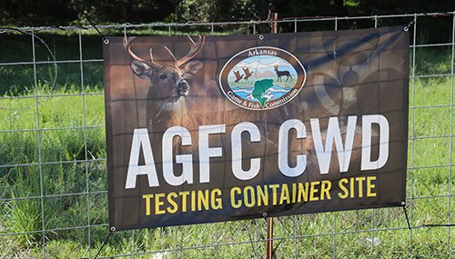 AGFC CWD Testing Container Site banner hanging on fence