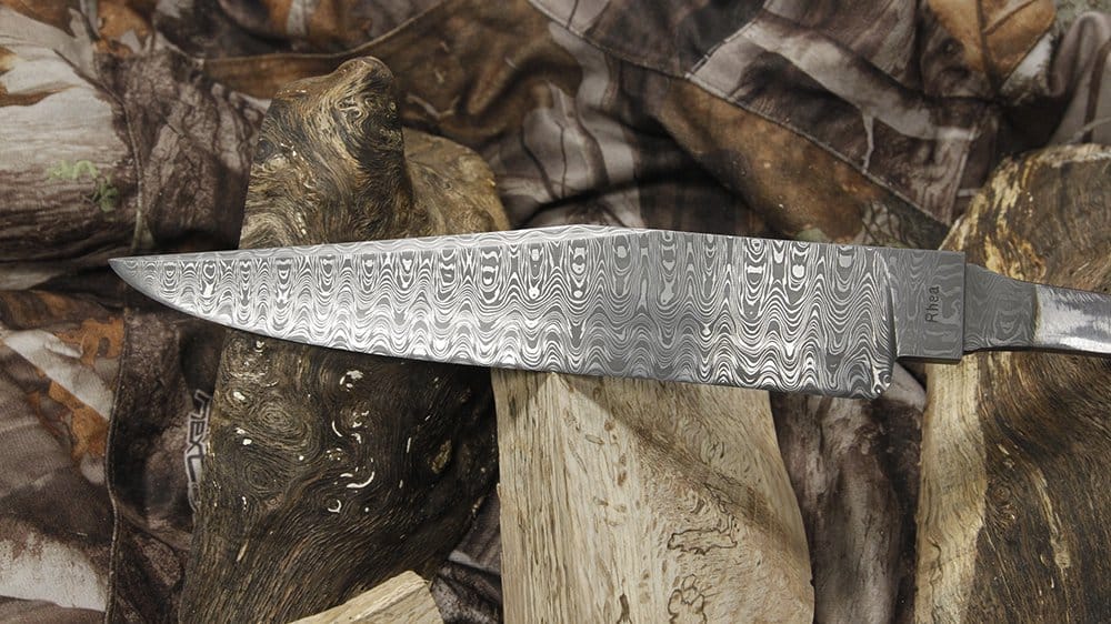 This Damascus knife was handcrafted by Rhea using different metals to create an intricate pattern.