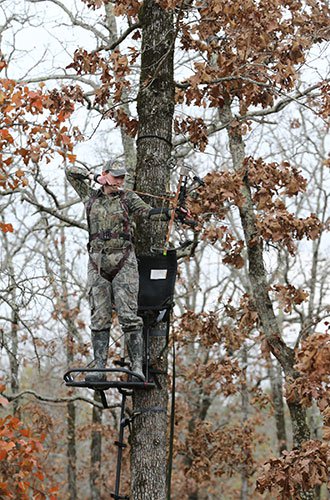 Archery hunter in tree stand