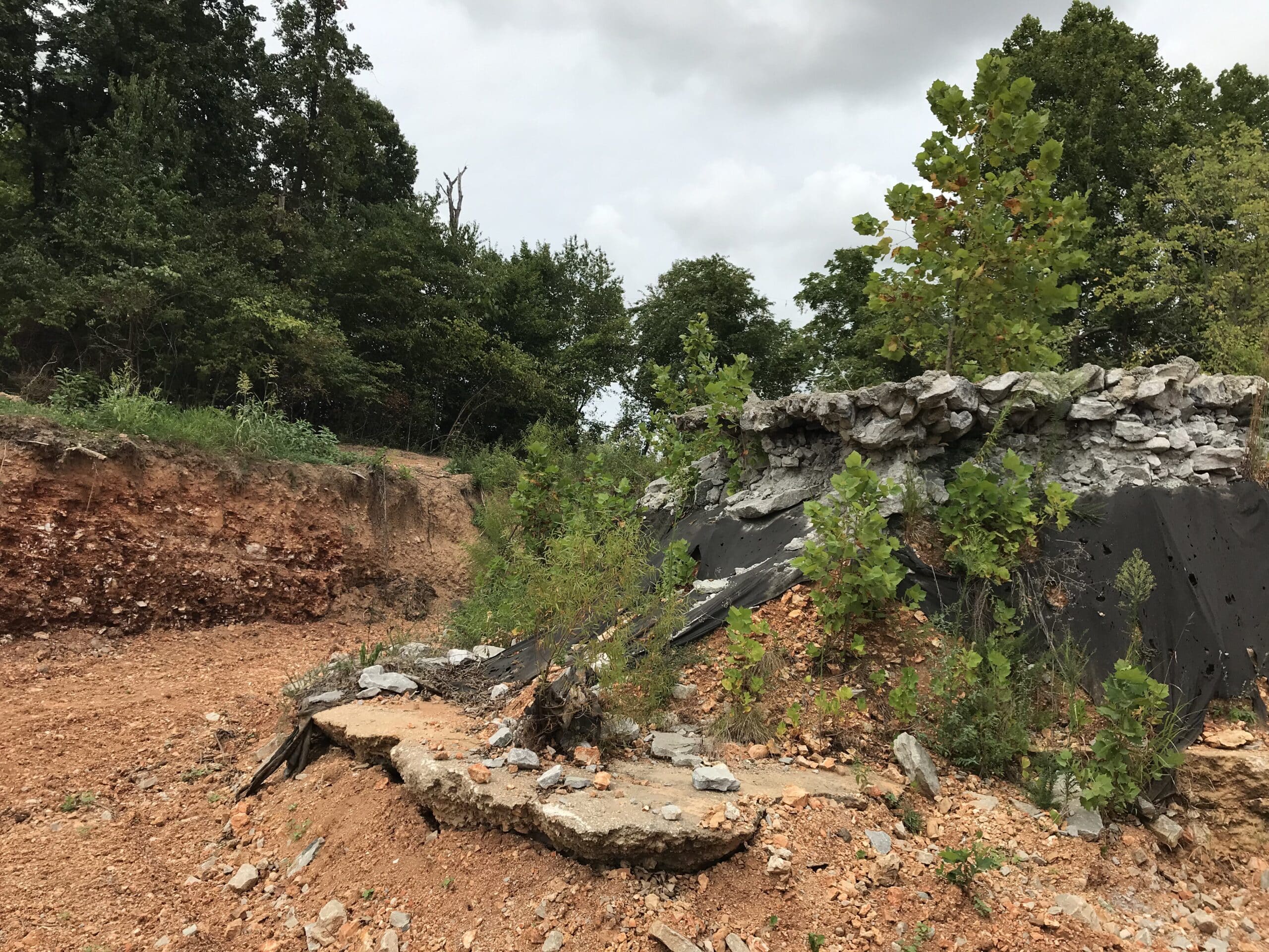 Construction underway to prevent further erosion of washed out spillway area