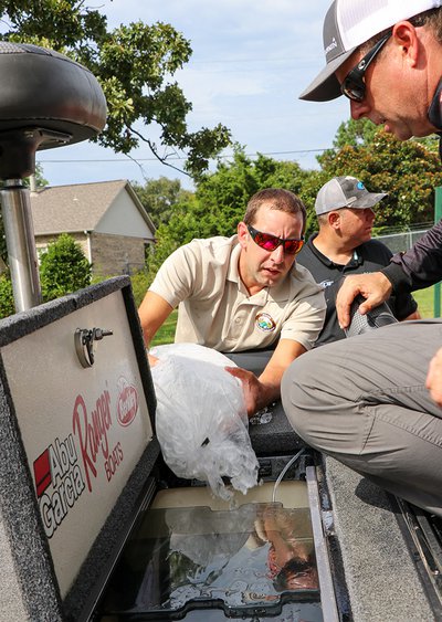 AGFC Black Bass Biologist Jeff Buckingham helping with fish care at the 2019 Forrest Wood Cup