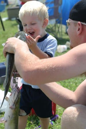 Young boy with a caught stocked catfish