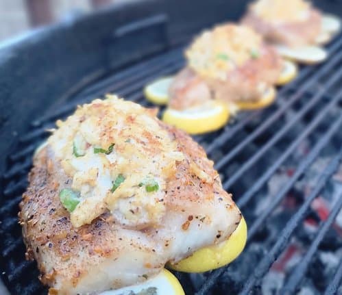 Grilling on a bed of lemon slices prevents the fish from burning and adds a smoky citrus flavor.