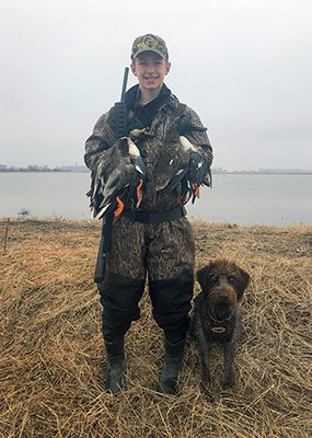 Youth duck hunter with dog
