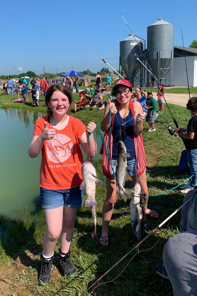 Girls with their catch at an AGFC fishing derby