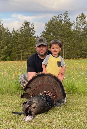 Brad Young with son and gobbler