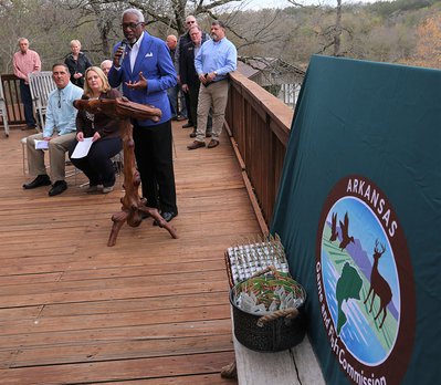 Fort Smith Mayor George McGill speaks to a crowd; seated are Bruce Stanton of PRADCO and Tabbi Kinion of the AGFC.