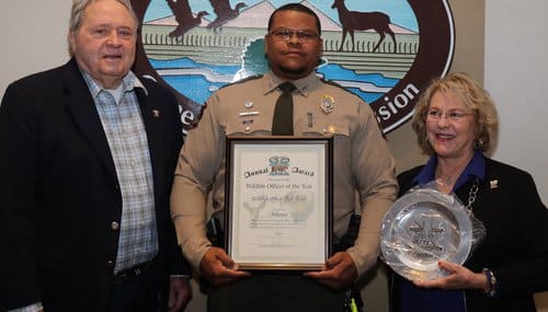 Mike Breedlove of Shikar Safari (left) and his wife Kay(right) present Wildlife Officer Rick Fields (center) with the Wildlife Officer of the Year Award.