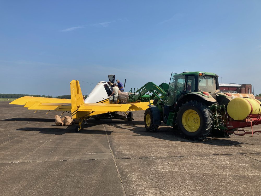 Loading Plane More than 6,800 pounds of seed was loaded and flown in one day.