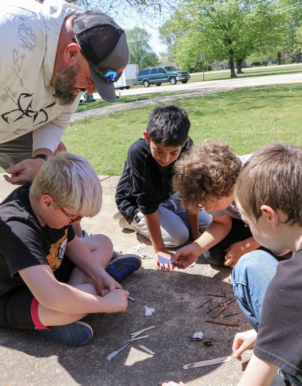 Freddy Penka oversees students during a campfire-building program. AGFC photo.