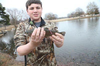 Young angler showing off tagged trout