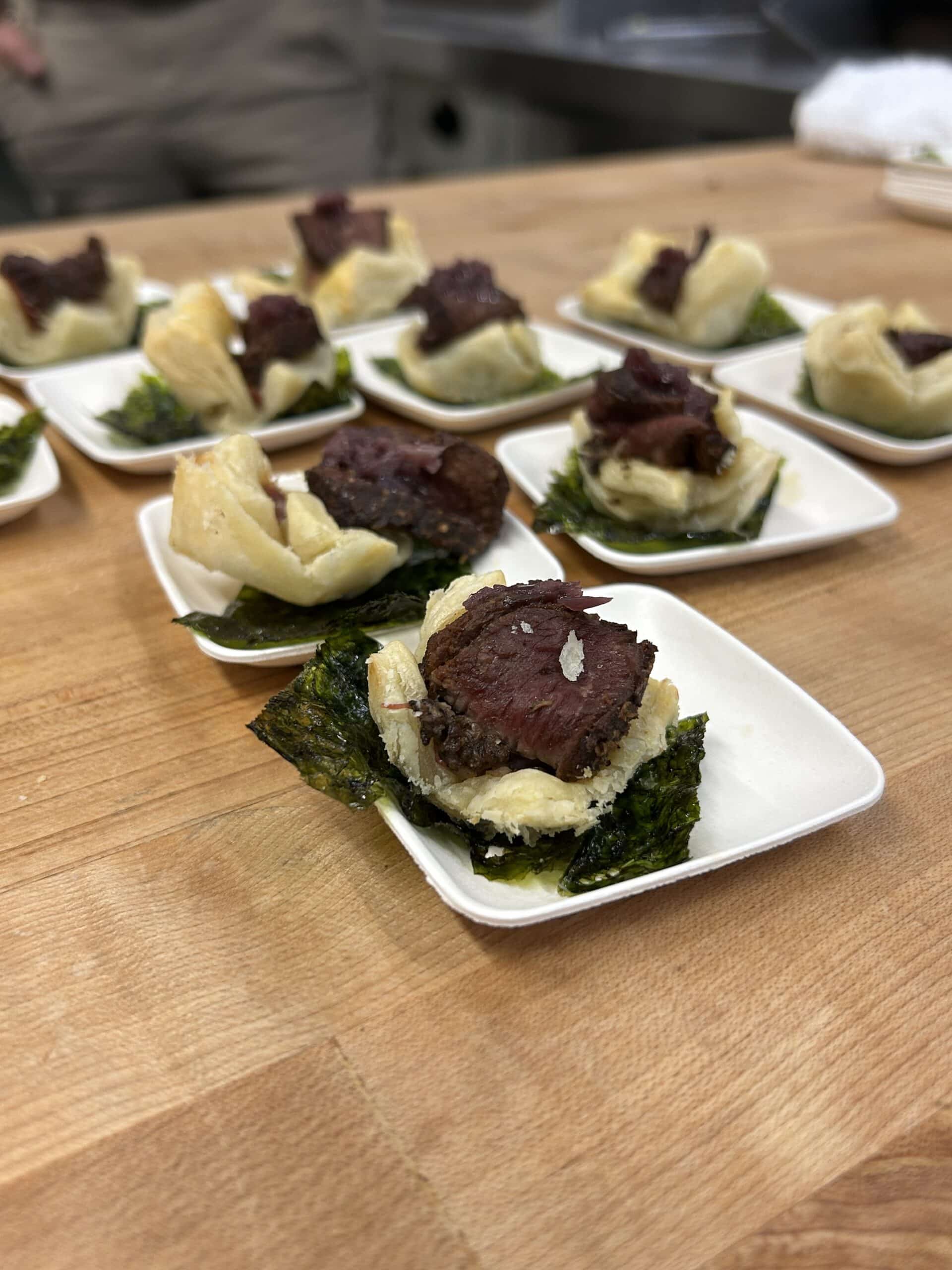 Venison cubes served on a small pastry.