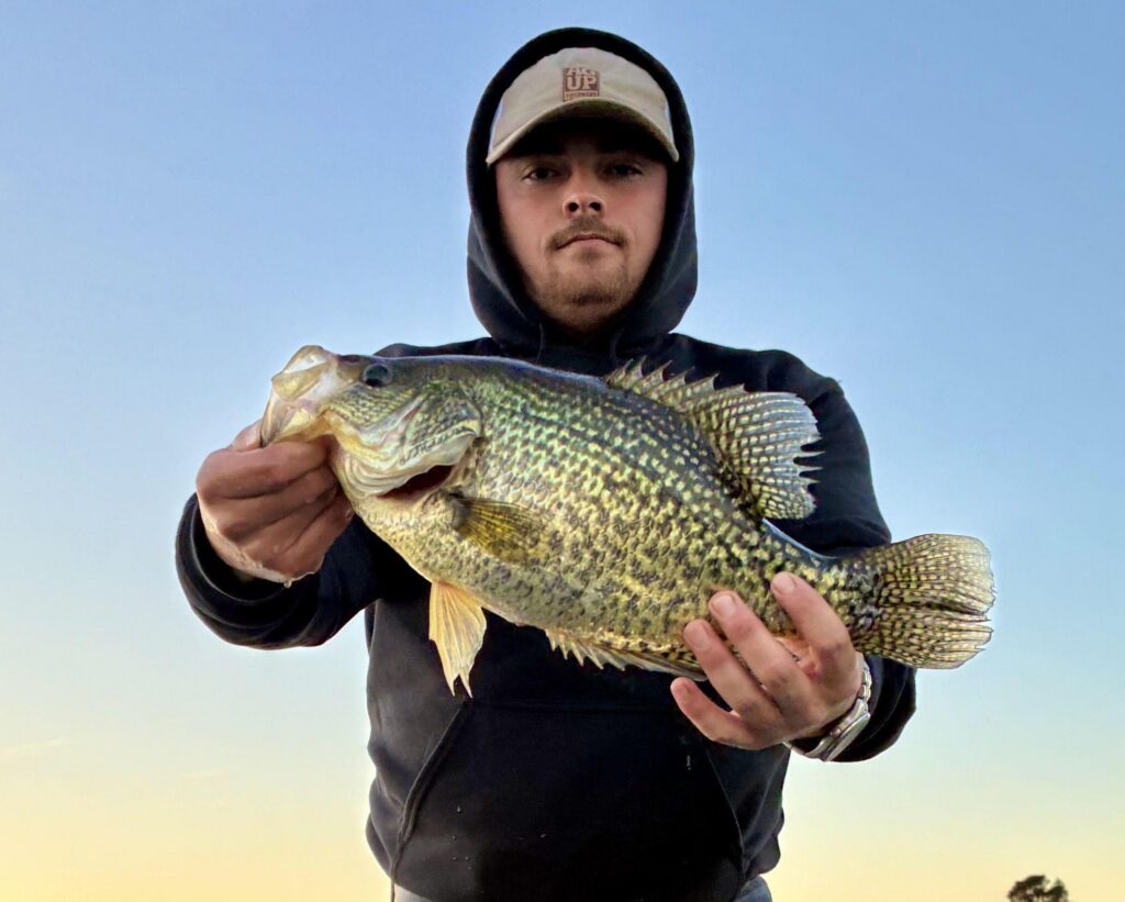 MAN WITH CRAPPIE: Not only were the bass biting great for Dereck Bates recently at Lake Monticello; on another trip, the angler also hauled in a black crappie weighing 3.1 pounds.