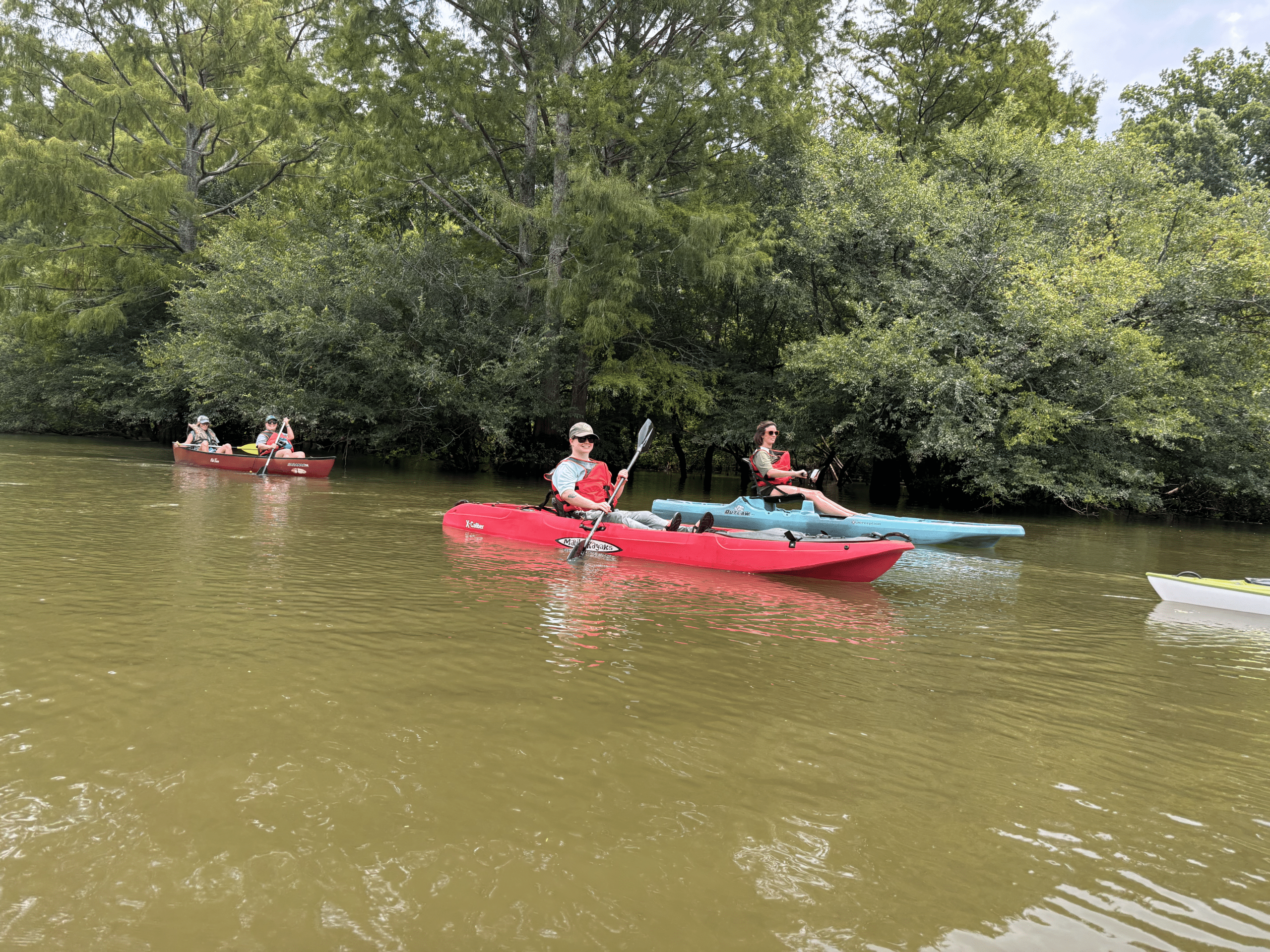 Teachers in kayaks in the river.