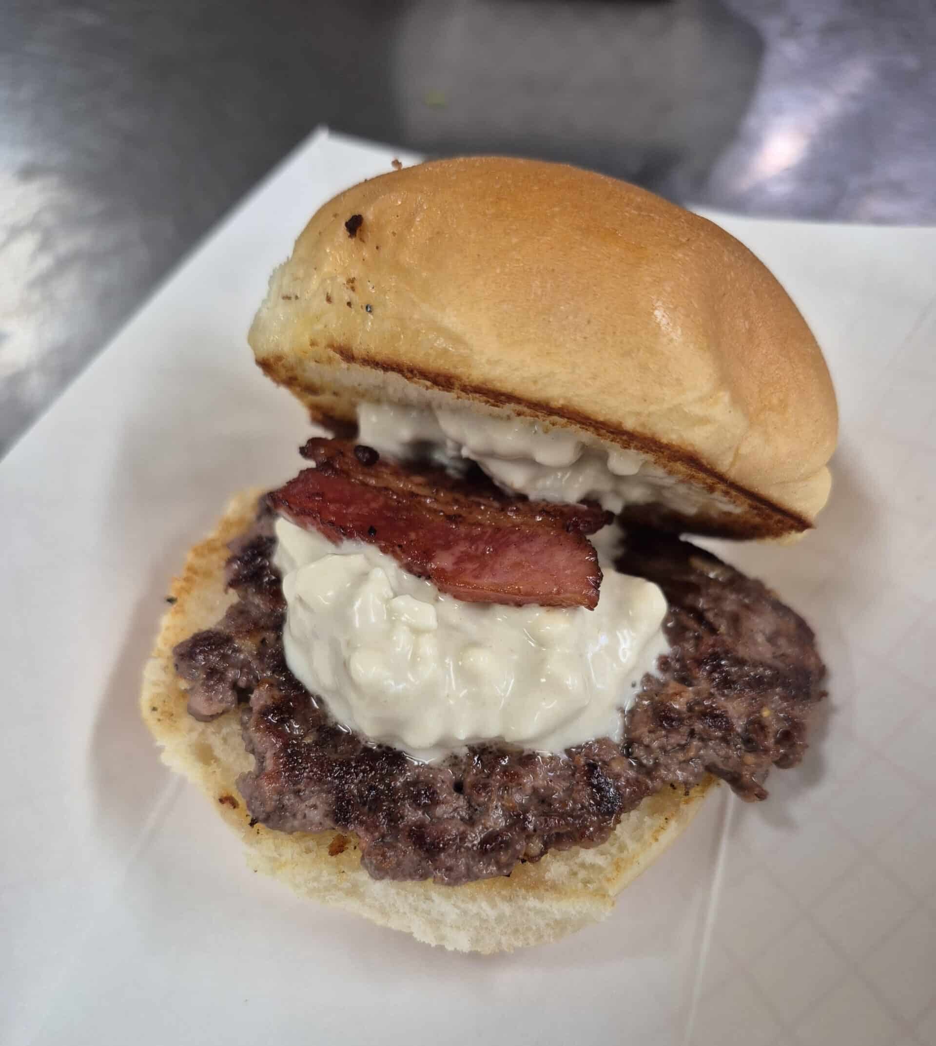 A slider with goose and blue cheese crumbles.