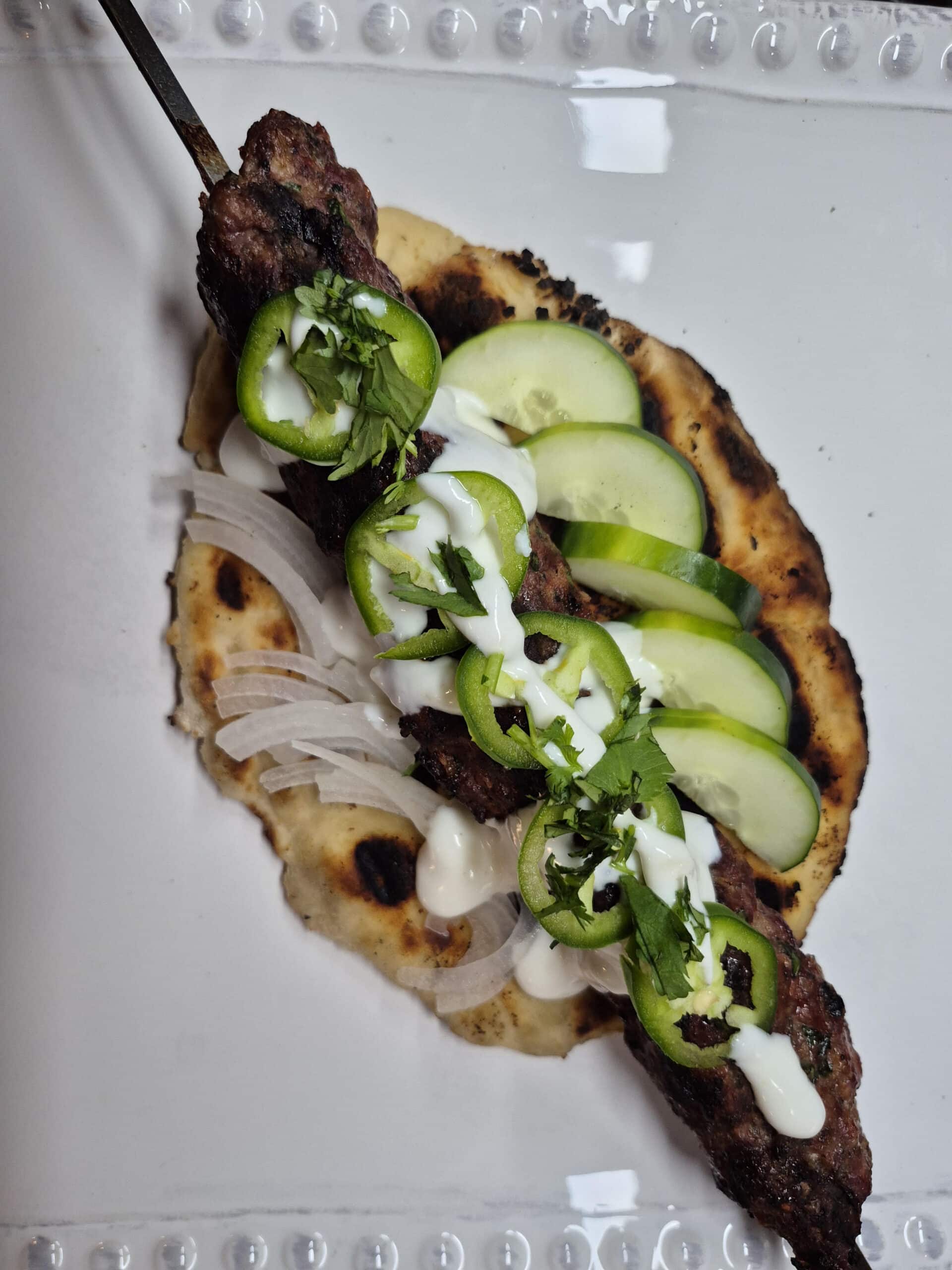 Grilled venison kebab on homemade naan bread.